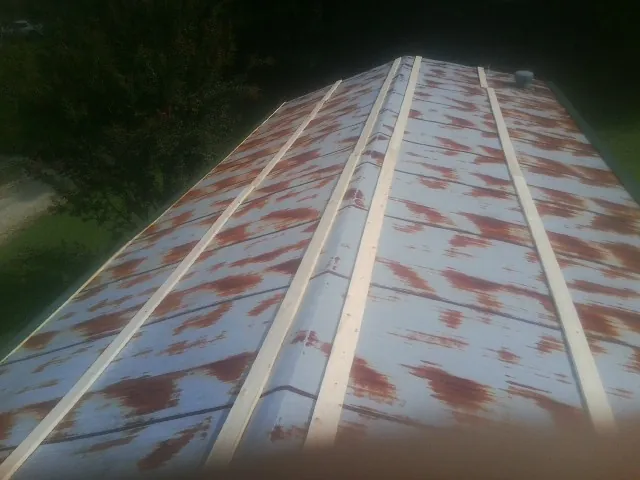 Rusted metal roof panels with new wood purlins before replacement — Storm Damage Roof Repair in New Trenton by Roofing Brothers