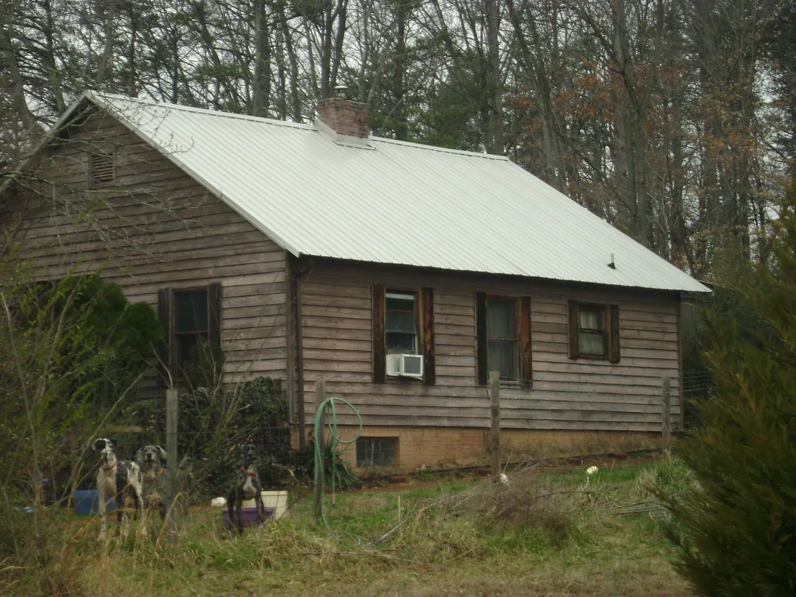 White metal roof on an old wood sided farmhouse, from a Asphalt Shingle Roof Repair job in New Trenton
